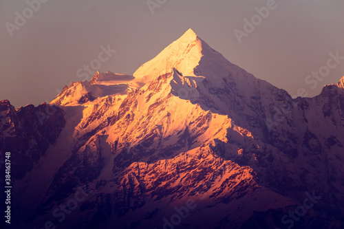 A snow capped Himalayn mountain at dusk