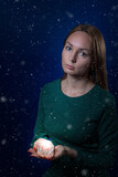 Cute young woman holding candle. Concept of winter, Christmas and spirituality.