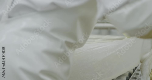 Soybean factory worker removing plastic sheet from soybean block photo