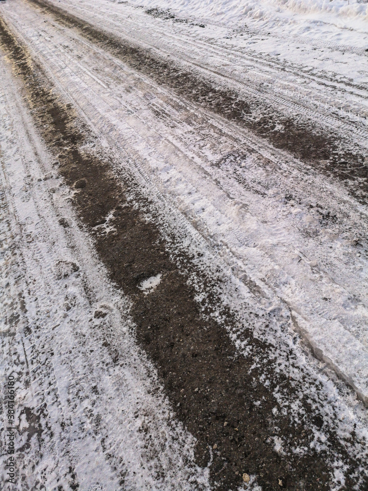 Fototapeta premium Car tracks on frozen ground as background.