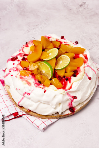 Pavlova Meringue Cake Decorated With Peach Berry Jam and Lime Tasty Homemade Summer Dessert Vertical