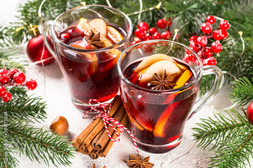 Mulled wine with christmas decorations on white.