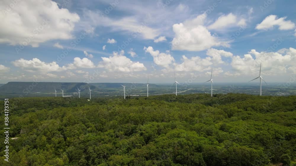 Many wind turbines for generating electricity on the grasslands with mountains and sky as a background in Thailand. Many wind turbines for generating electricity on the grasslands with mountains and sky as a background in Thailand.