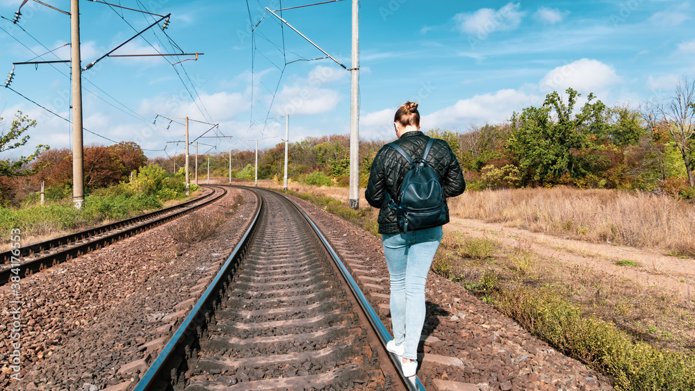Woman walking on rails