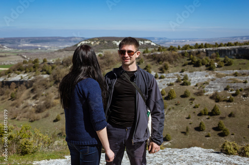 A man and a woman on top of a mountain