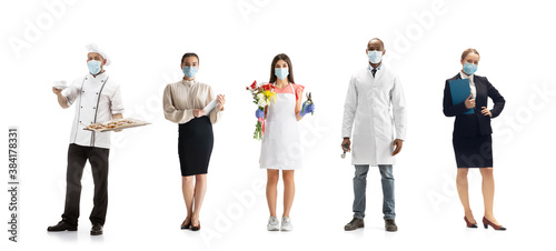 Group of people with different professions on white studio background, horizontal. Modern workers of diverse occupations, male and female models like florist, doctor, accountant, baker in face masks