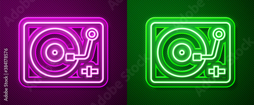 Glowing neon line Vinyl player with a vinyl disk icon isolated on purple and green background. Vector.