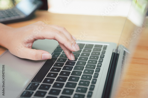 Closeup of businesswoman hands on laptop at office desk. woman using laptop for searching web or browsing information, home office concept.