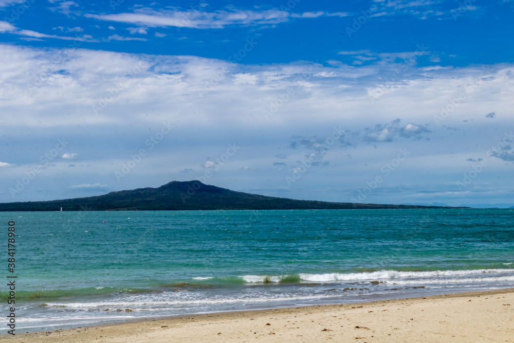 Surf rolling in on the beach. Takapuna Beach, Auckland, New Zealand