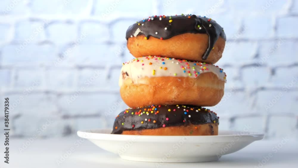 stack of chocolate donuts on plate with copy space 