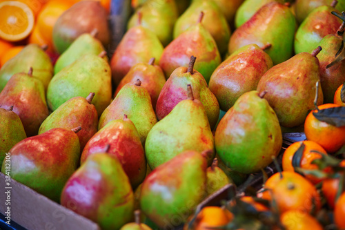 Large heap of fresh ripe organic pears on farmer market in Paris