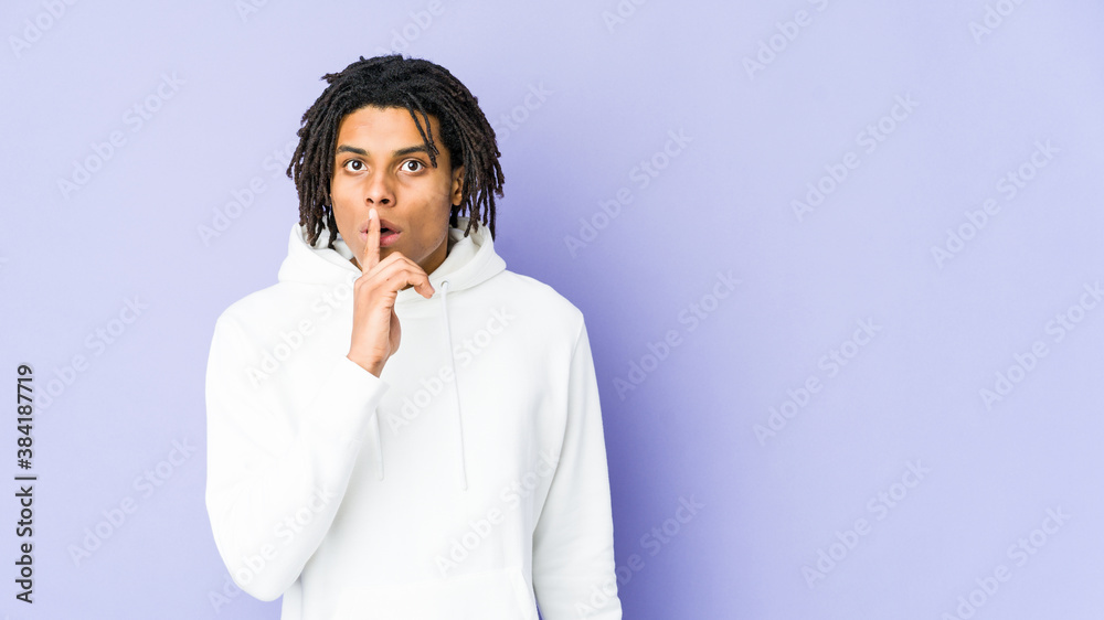 Young african american rasta man keeping a secret or asking for silence. Young african american rasta man keeping a secret or asking for silence.