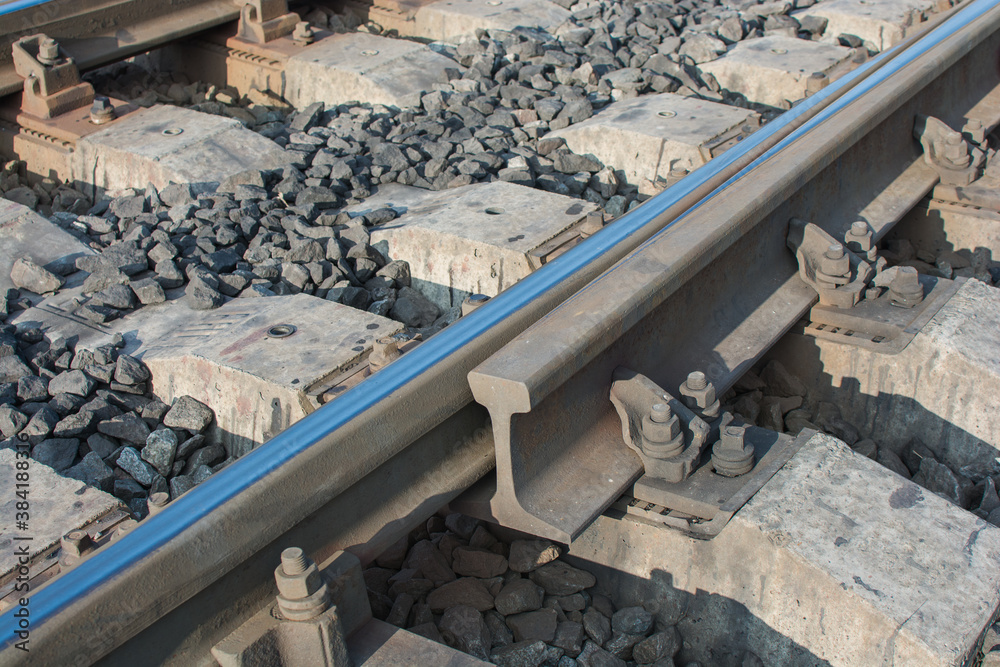 close-up of the connection of railway rails, the rolled track from the trains is visible. Horizontal photo close-up of the connection of railway rails, the rolled track from the trains is visible. Horizontal photo