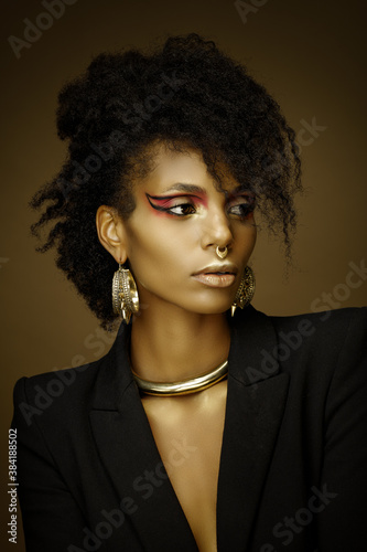 Beautiful afro girl wearing a blazer and gold jewelry