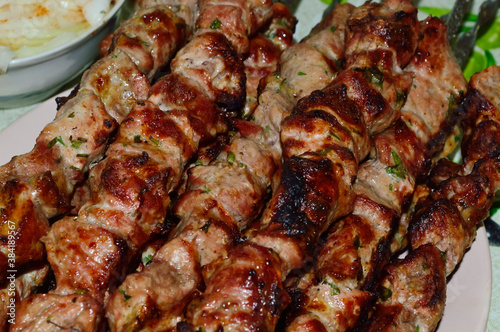 close-up - appetizing tasty shish kebab - marinated pieces of meat fried on skewers