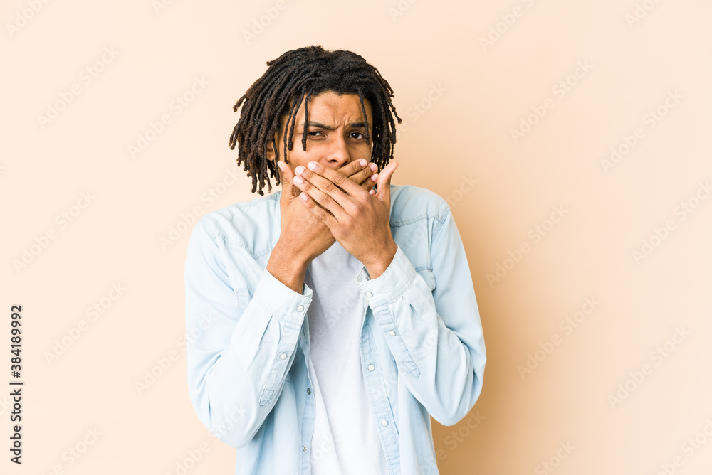 Young african american rasta man covering mouth with hands looking worried. Young african american rasta man covering mouth with hands looking worried.