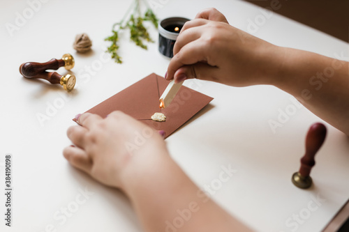 sealing wax is dropped on the brown envelope for printing