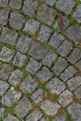 Abstract background of an old cobblestone street close-up.