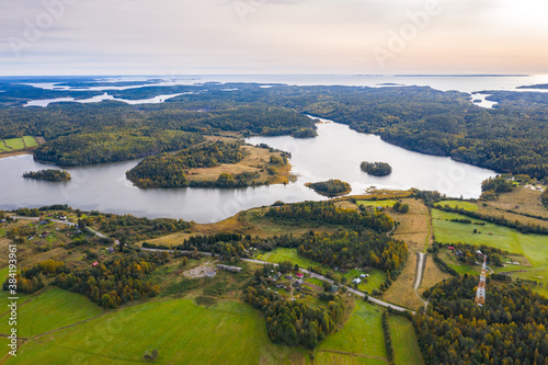 Aerial top view of nature in Karelia. Green forest, river, lake. Autumn landscape. Russia