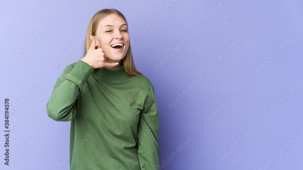 Young blonde woman isolated on purple background showing a mobile phone call gesture with fingers. Young blonde woman isolated on purple background showing a mobile phone call gesture with fingers.