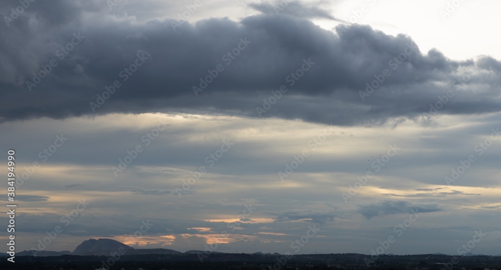 A Panoramic Silhouette of low hills in wide angle view and beautiful clouds formation in the Horizon A Panoramic Silhouette of low hills in wide angle view and beautiful clouds formation in the Horizon