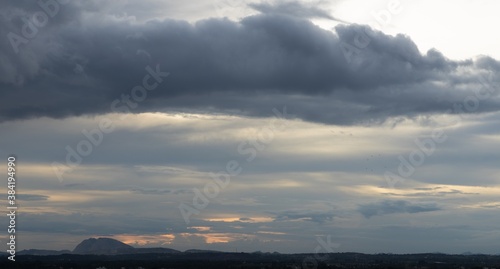A Panoramic Silhouette of low hills in wide angle view and beautiful clouds formation in the Horizon