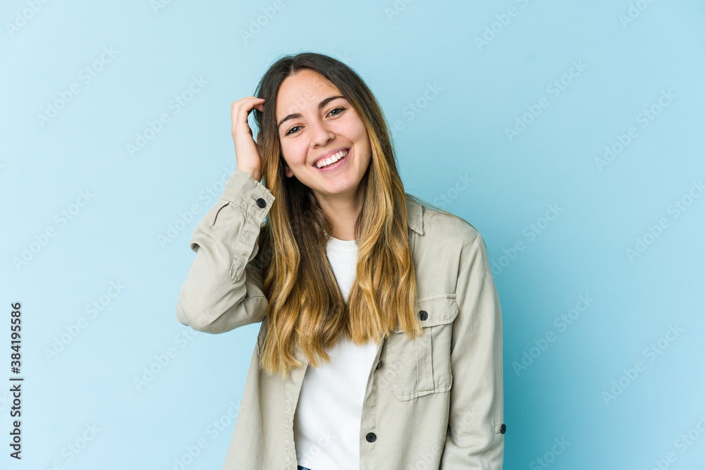 Young caucasian woman isolated on blue background joyful laughing a lot. Happiness concept. Young caucasian woman isolated on blue background joyful laughing a lot. Happiness concept.