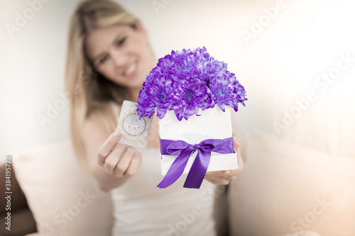 Photography The young blonde holds a bouquet of flowers in her hands in a decorative box she received from a man she loves