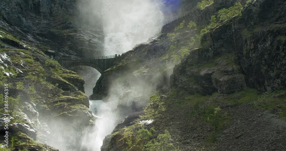 Water flowing in Stigfossen waterfall under traffic bridge on scenic Norway Trolls Road route Water flowing in Stigfossen waterfall under traffic bridge on scenic Norway Trolls Road route