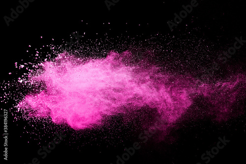 Pink powder explosion on black background. Paint Holi. © piyaphong