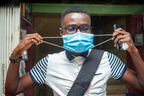 close up image of african man, with face mask for protection