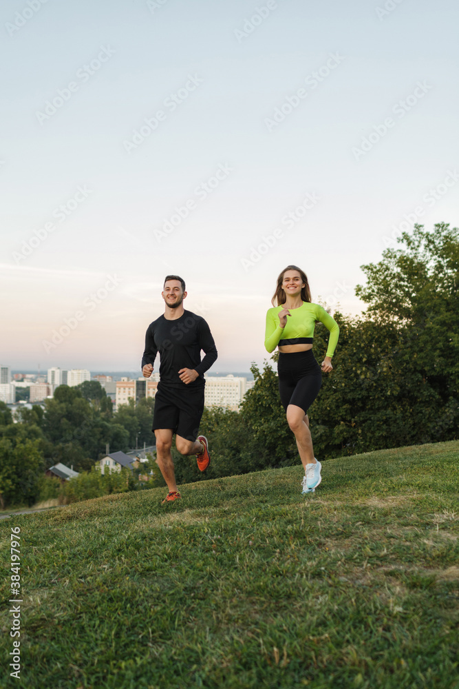 Couple running outdoors, at sunset, staying active and fit