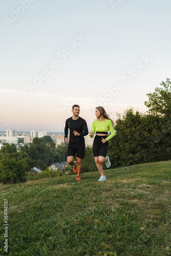 Couple running outdoors, at sunset, staying active and fit