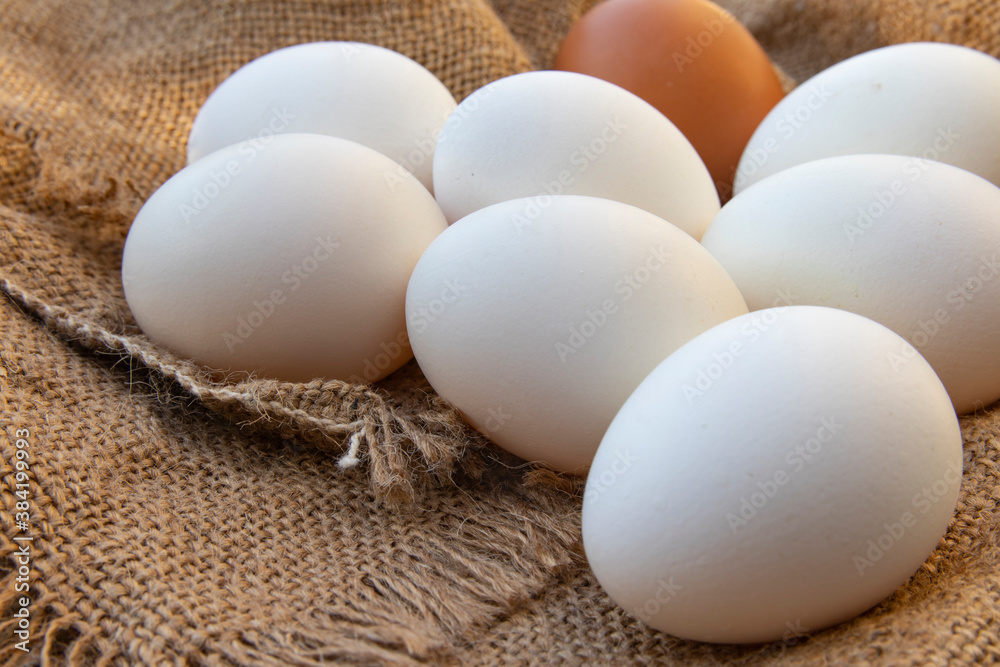 Organic raw chicken eggs on burlap cloth. Fresh chicken eggs. Organic raw chicken eggs on burlap cloth. Fresh chicken eggs.