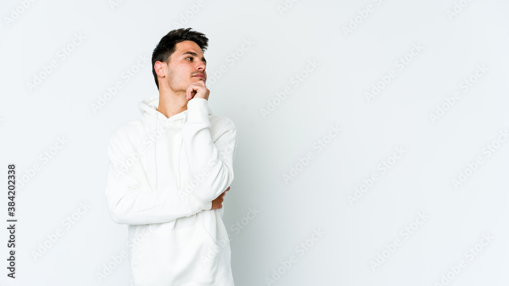 Young caucasian man isolated on white background looking sideways with doubtful and skeptical expression. Young caucasian man isolated on white background looking sideways with doubtful and skeptical expression.