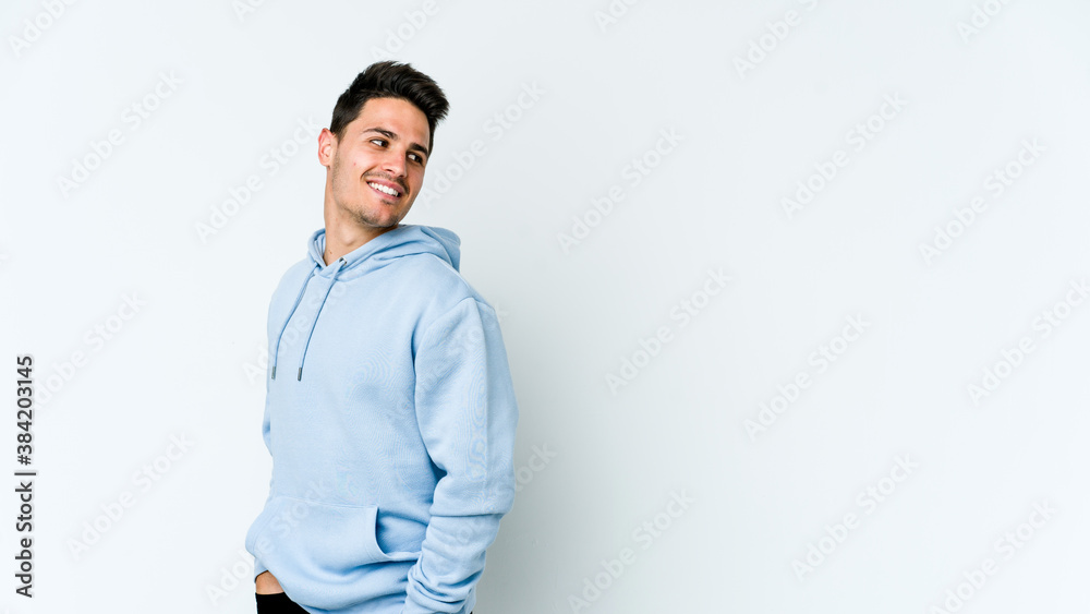 Young caucasian man isolated on white background looks aside smiling, cheerful and pleasant. Young caucasian man isolated on white background looks aside smiling, cheerful and pleasant.