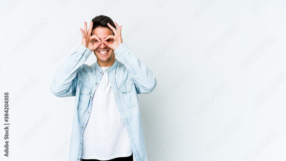Young caucasian man isolated on white background excited keeping ok gesture on eye. Young caucasian man isolated on white background excited keeping ok gesture on eye.