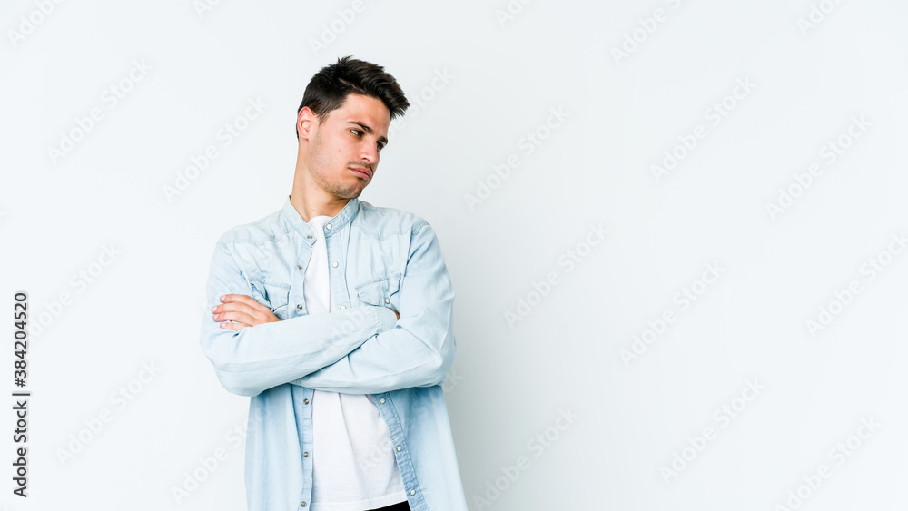 Young caucasian man isolated on white background tired of a repetitive task.