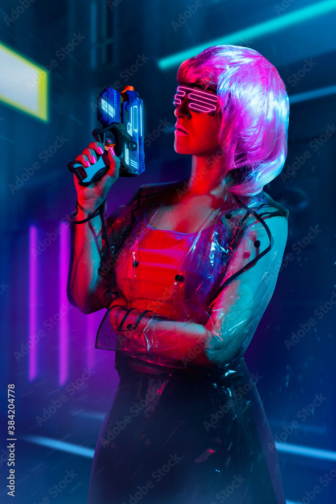 Cyberpunk pink haired woman in neon glasses and transparent raincoat ...