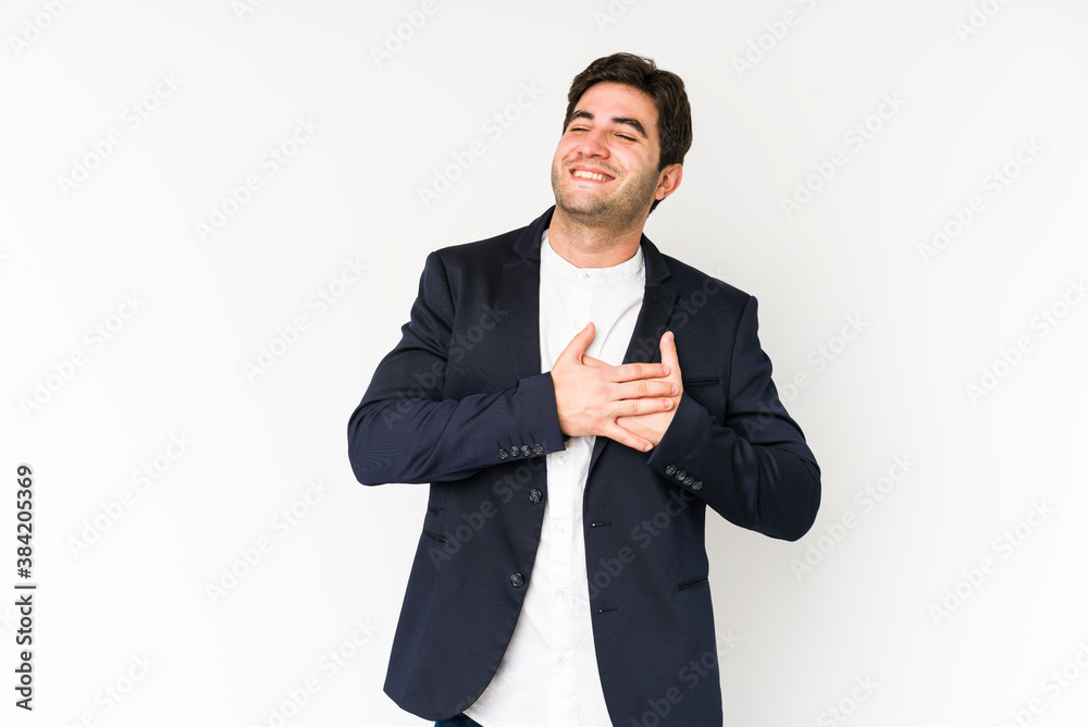 Young business man isolated on white background has friendly expression, pressing palm to chest. Love concept. Young business man isolated on white background has friendly expression, pressing palm to chest. Love concept.