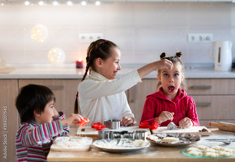Children preparing cookies and having fun at home Children preparing cookies and having fun at home