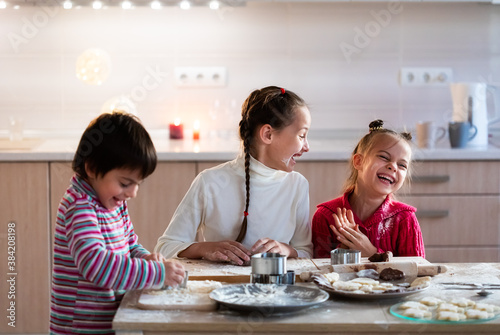 Children preparing cookies and having fun at home