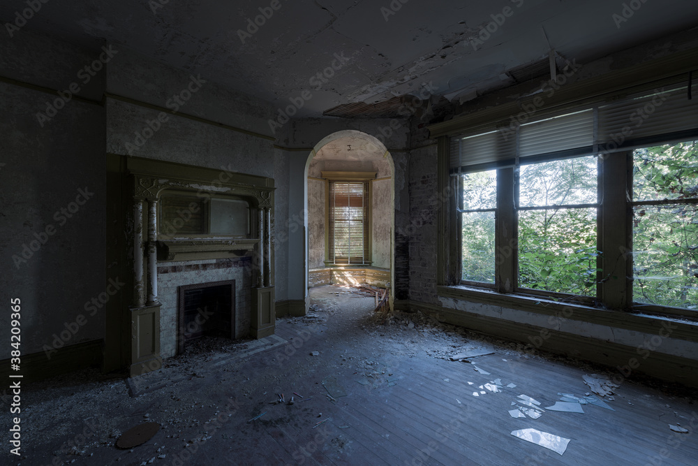 This is an interior view of the corner room with a fireplace and turret at the long-abandoned and historic Dunnington Mansion in Farmville, Virginia.