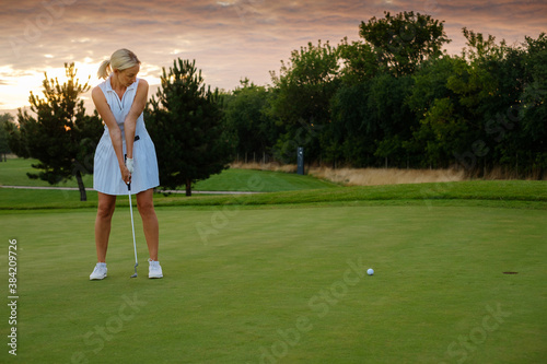 Lady Try Hit Golf Ball Into Hole .