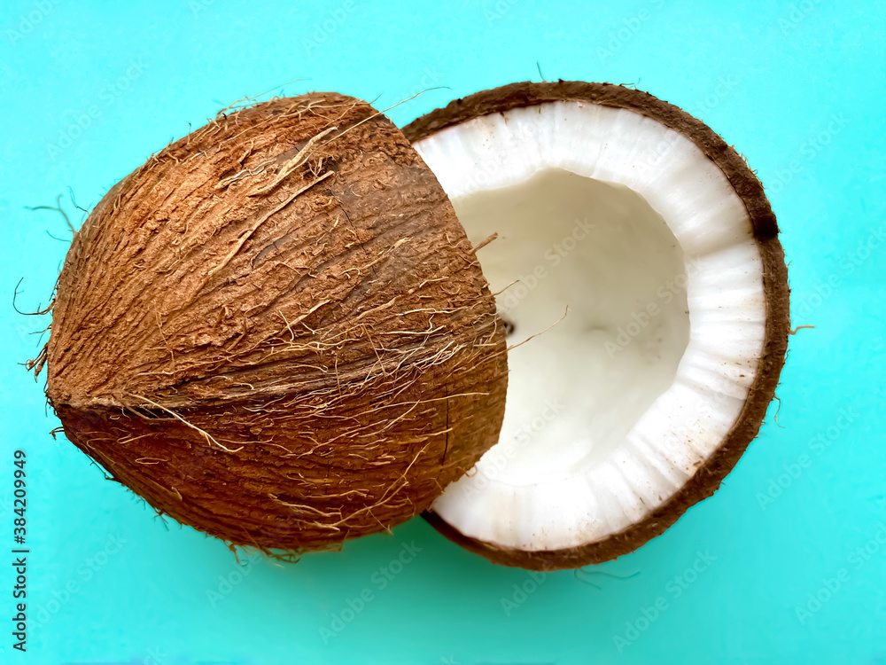 Close-up of coconut halves on a bright blue background.