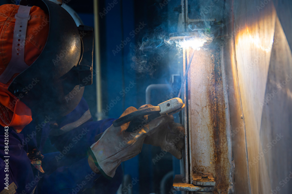 Welder is assembling the workpiece by process shielded metal arc