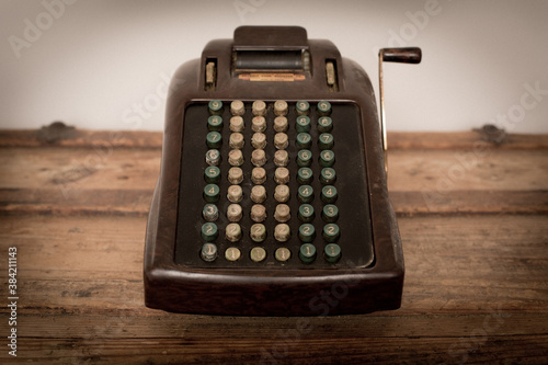 Vintage Adding Machine Sitting on Old Wooden Trunk