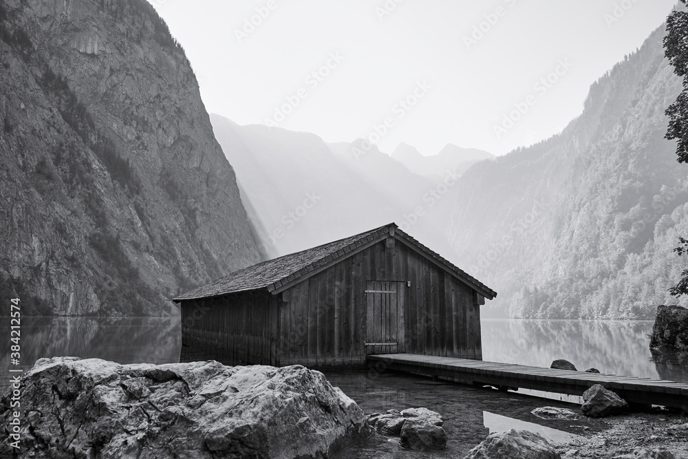 Wooden boathouse at Lake Obersee with alpine landscape, Schoenau am Koenigssee, Germany