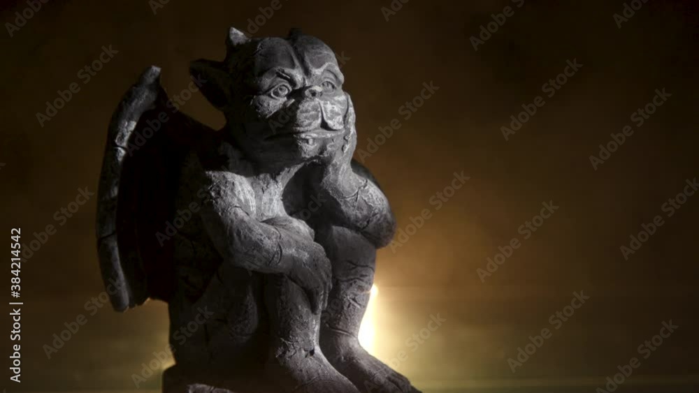 A creepy little gargoyle statuette with eerie fog and a flickering light surrounding it. A creepy little gargoyle statuette with eerie fog and a flickering light surrounding it.
