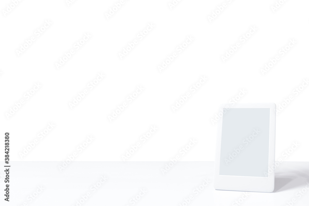 single ebook with white screen and white background on the table. mockup design. E-reader tablet. space to write